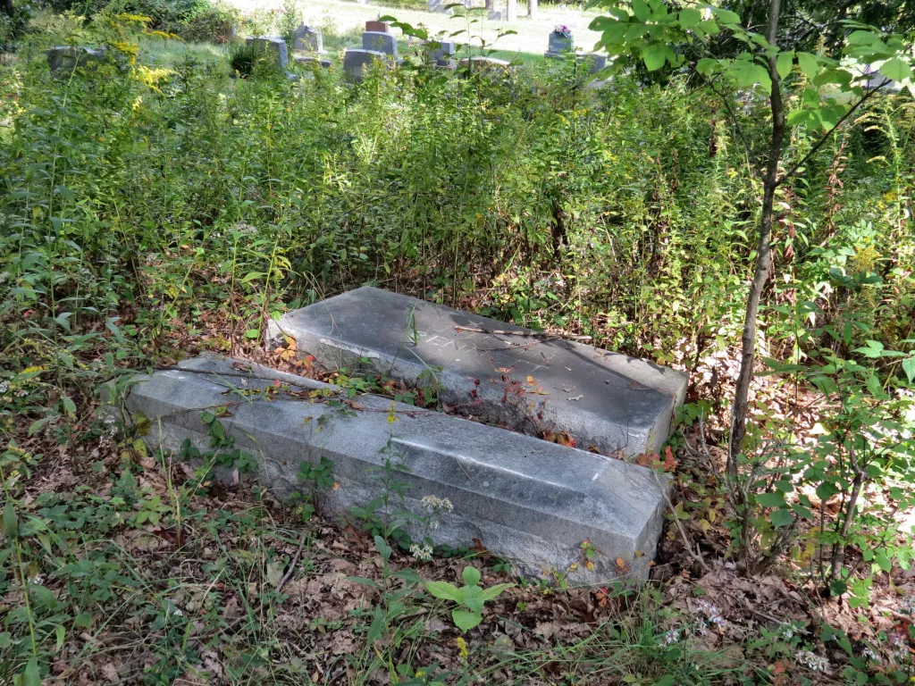 One of many toppled headstones